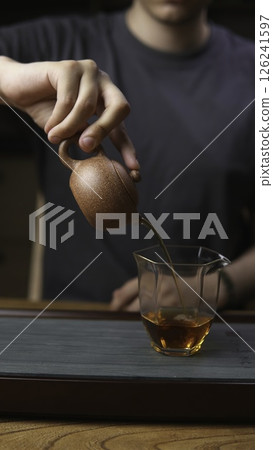 An Artisan Tea Setup with a Teapot and Glass Cup, enhancing the serene experience of brewing. Media An Artisan Tea Setup with a Teapot and Glass Cup, enhancing the serene experience of brewing. Media 126241597