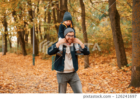 In the autumn forest. Father and young son is together outdoors at daytime 126241697