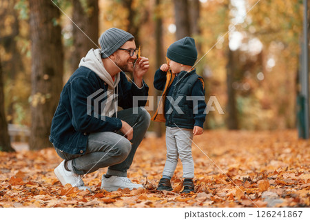 Father and young son is together outdoors at daytime 126241867