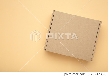 Brown Paper box Cardboard box on beige background Brown Paper box Cardboard box on beige background 126242389