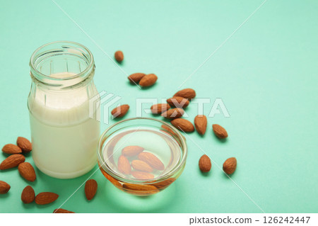 Almond milk and oil on mint background. Top view 126242447