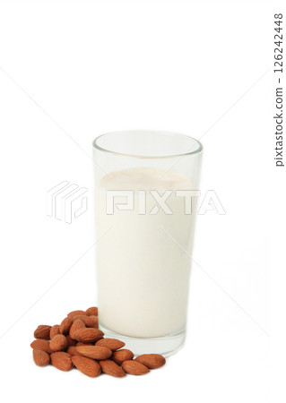 Fresh almond milk in glass and almonds isolated on white background. Healthy vegan plant based alternative milk replacer. Top view Fresh almond milk in glass and almonds isolated on white background. Healthy vegan plant based alternative milk replacer. Top view 126242448