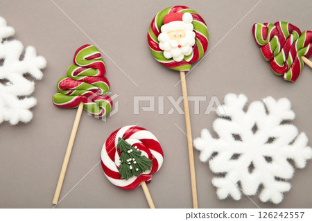 Christmas Candy with white snowflakes on grey background. Sweet lollipop Christmas Candy with white snowflakes on grey background. Sweet lollipop 126242557