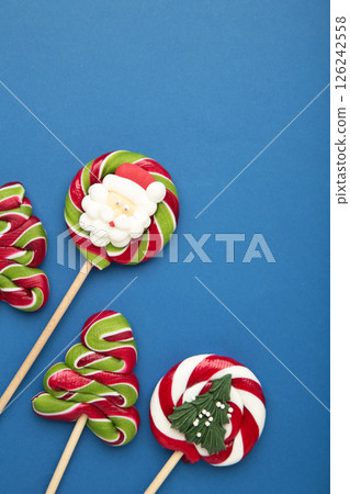 Christmas Candy on blue background. Sweet lollipop. Vertical photo Christmas Candy on blue background. Sweet lollipop. Vertical photo 126242558