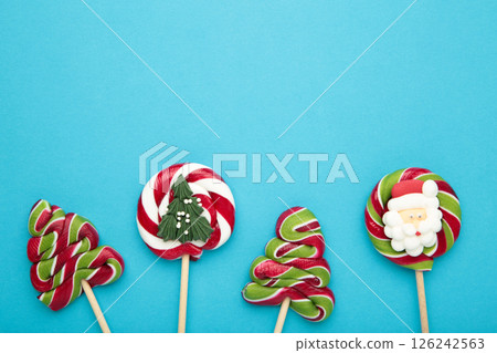 Christmas Candy on blue background. Sweet lollipop. Christmas Candy on blue background. Sweet lollipop. 126242563