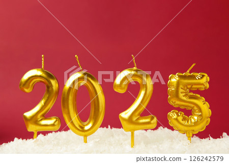 Holiday background Happy New Year 2025. Numbers of year 2025 made by gold candles on red background with snow. Holiday background Happy New Year 2025. Numbers of year 2025 made by gold candles on red background with snow. 126242579