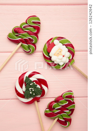 Christmas Candy on pink wooden background. Sweet lollipop. Vertical photo 126242642
