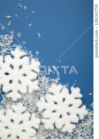 Beautiful snowflakes with snow on blue background. Vertical photo 126242759