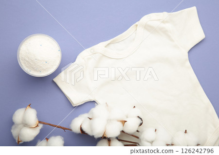 Laundry detergent products with white baby cloth and cotton flower on purple background. Vertical photo Laundry detergent products with white baby cloth and cotton flower on purple background. Vertical photo 126242796