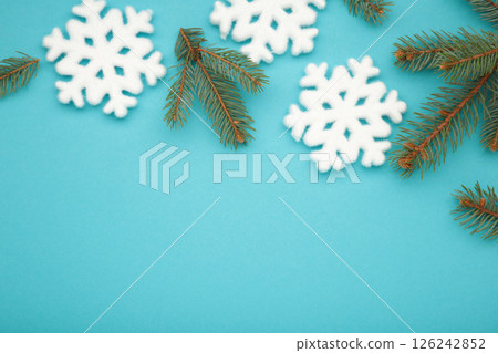 Christmas composition with fir tree branches and snowflakes on blue background. Top view Christmas composition with fir tree branches and snowflakes on blue background. Top view 126242852