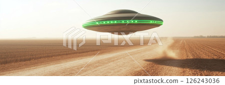 UFO with glowing green lights hovering over a dusty field at sunset, sci-fi background 126243036