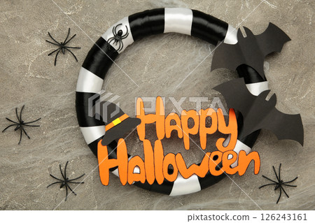 Halloween wreath with spiders on grey concrete background. Thanksgiving decor. Top view 126243161