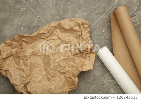 Rolls of white and brown baking paper on grey concrete background 126243515