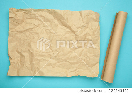 Rolls of white and brown baking paper on blue background Rolls of white and brown baking paper on blue background 126243533