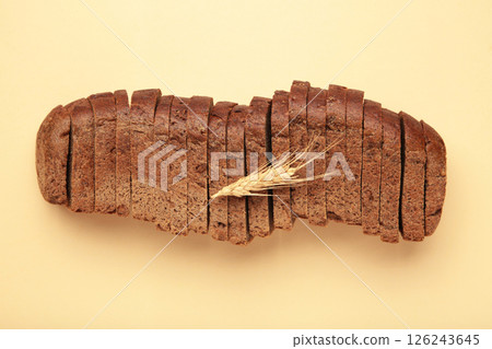 Fresh sliced rye bread loaf on beige background 126243645