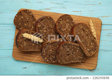 Fresh sliced rye bread loaf on blue background 126243646