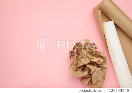 Rolls of white and brown baking paper on pink background Rolls of white and brown baking paper on pink background 126243649
