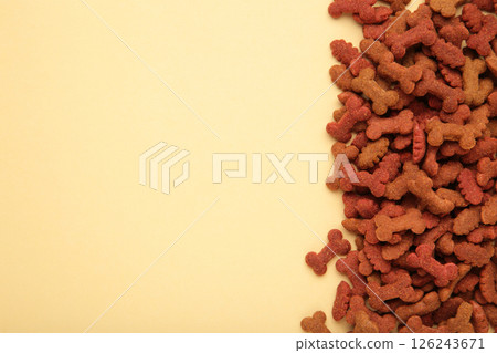 Healthy dry pet food for dogs on beige background. 126243671
