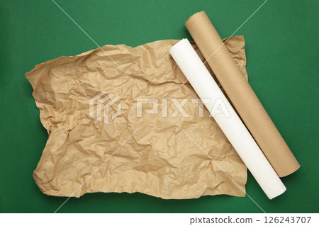 Rolls of white and brown baking paper on green background 126243707