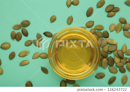 Pumpkin seed oil and seeds on mint background. 126243722