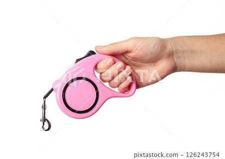 A hand holding a retractable dog leash isolated on white background. A hand holding a retractable dog leash isolated on white background. 126243754