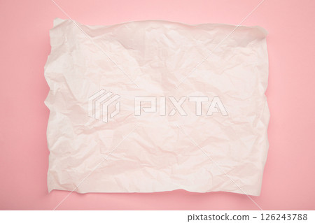 Crumpled piece of white parchment or baking paper on pink background. Copy space for text and design element. Crumpled piece of white parchment or baking paper on pink background. Copy space for text and design element. 126243788