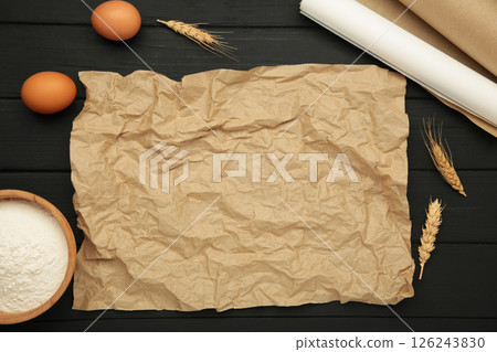Prepare to baking. Dough ball near cookware on black wooden background top view. Mock up with baking paper 126243830