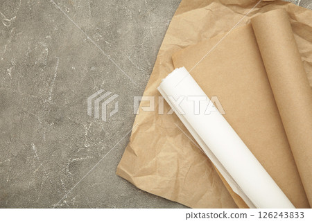 Rolls of white and brown baking paper on grey concrete background 126243833