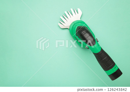 Hedge Trimmer New cordless hedge trimmer on mint background Hedge Trimmer New cordless hedge trimmer on mint background 126243842