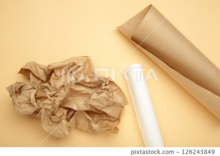 Rolls of white and brown baking paper on beige background 126243849