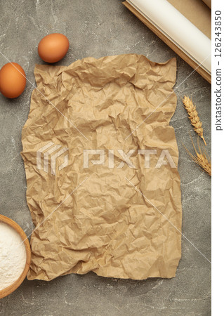 Prepare to baking. Dough ball near cookware on grey concrete background top view. Mock up with baking paper 126243850