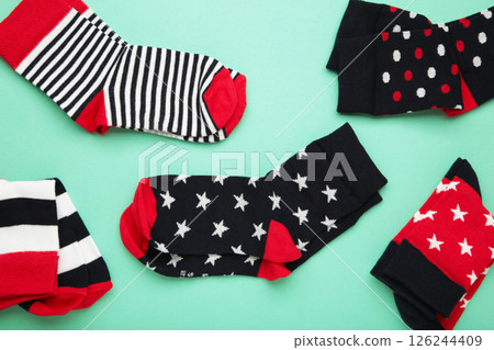 Pair of cute child socks on mint background, top view 126244409