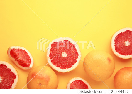 Fresh raw grapefruit on yellow background 126244422