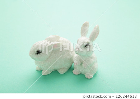 White ceramic rabbit on mint background. Space for text 126244618