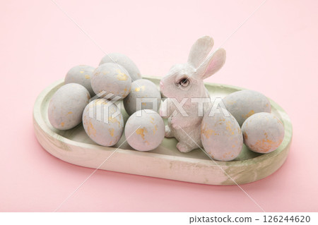 Colorful easter eggs and ceramic bunny figurines on pink background 126244620