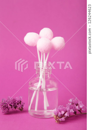 Air freshener on pink. White aroma diffuser bottle with sticks. Minimalism. Top view 126244623