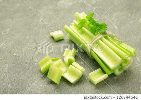 Fresh green cut celery on grey concrete background 126244646