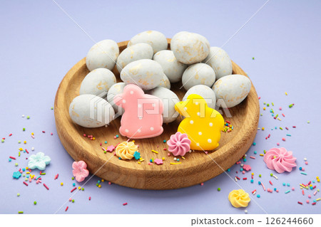 Gingerbread Easter figures - rabbit with easter egg on purple background. Happy Easter, spring concept 126244660