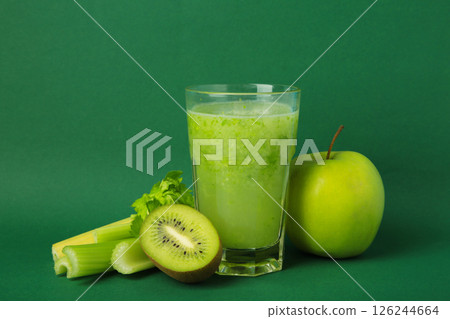 Green smoothie in glass made from kiwi, celery, apples. Detox concept, healthy food, diet, vegetarian. Smoothie on green 126244664
