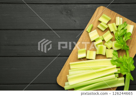 Fresh green cut celery on black wooden background 126244665
