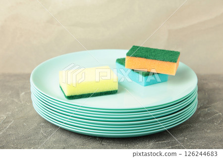 Cleaning sponge with plate on grey concrete background. top view 126244683