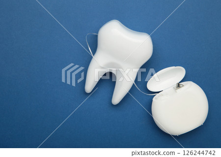 White healthy tooth with dental floss. Oral dental care products, hygiene cleaning personal use lifestyle concept 126244742