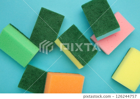 Sponge for dish cleaning on blue background Sponge for dish cleaning on blue background 126244757