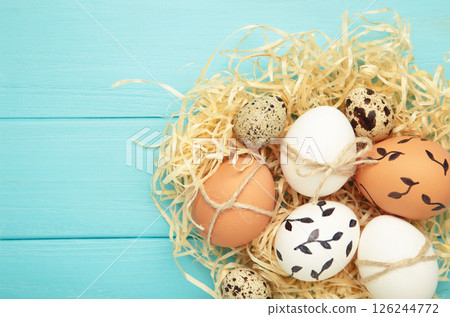 Composition with Easter eggs on blue wooden background 126244772