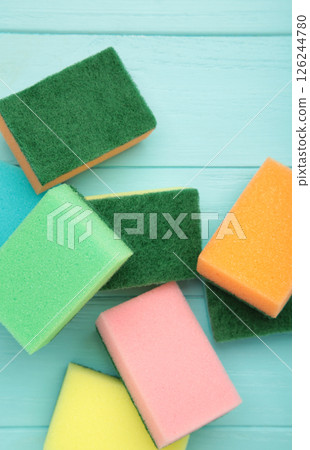 Sponge for dish cleaning on blue wooden background 126244780