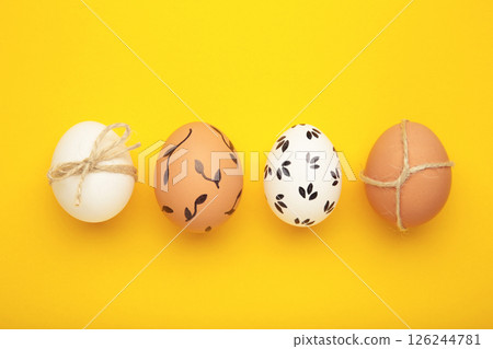 Easter background - white easter egg with flowers inside on yellow background. Happy easter, spring, summer floral concept 126244781