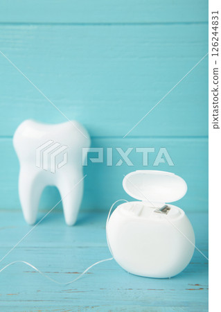 White healthy tooth with dental floss. Oral dental care products, hygiene cleaning personal use lifestyle concept 126244831