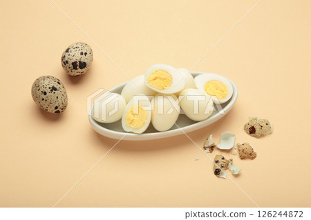 Boiled quail eggs on plate on beige background. Easter Boiled quail eggs on plate on beige background. Easter 126244872