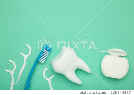 White healthy tooth with dental floss on mint. Oral dental care products, hygiene cleaning personal use lifestyle concept 126244877
