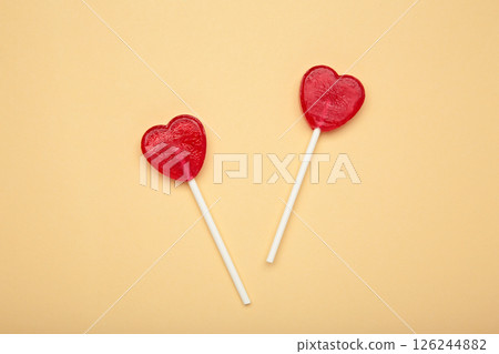 Sweet heart shaped lollipops on beige background. Valentine's day celebration 126244882
